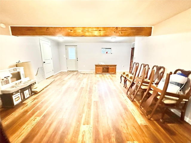 interior space with beam ceiling and light wood-type flooring