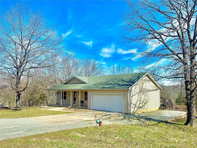 view of front facade featuring a garage, driveway, a front lawn, and a porch