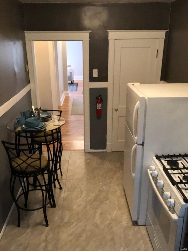 kitchen with white cabinets and white range with gas cooktop