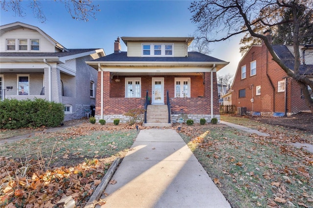 bungalow-style house featuring central AC and a porch