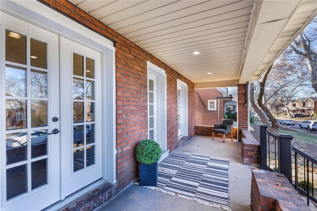 view of patio featuring french doors and a porch