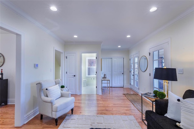 entrance foyer with light hardwood / wood-style floors and ornamental molding