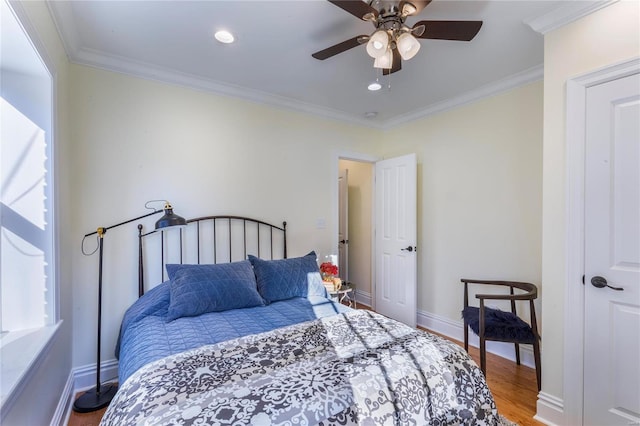 bedroom featuring hardwood / wood-style floors, ceiling fan, and ornamental molding