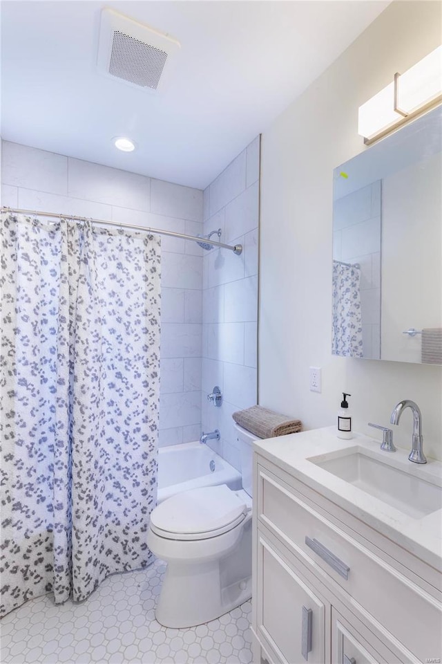 full bathroom with shower / bath combination with curtain, vanity, and toilet