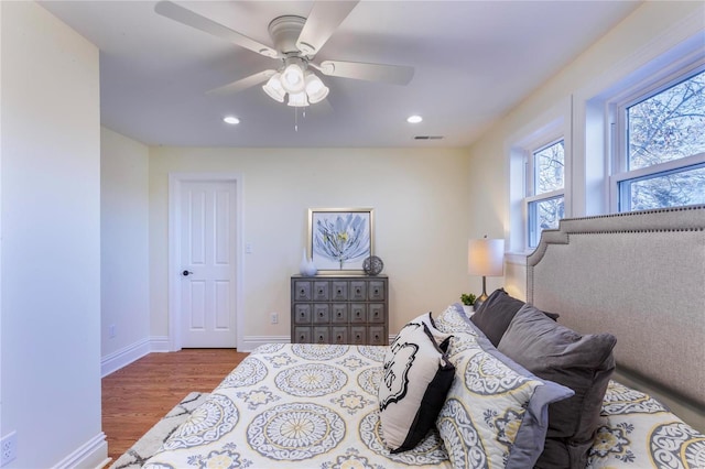 bedroom with ceiling fan and hardwood / wood-style floors