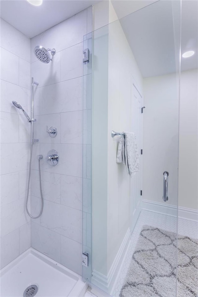 bathroom featuring tile patterned floors and a shower with shower door