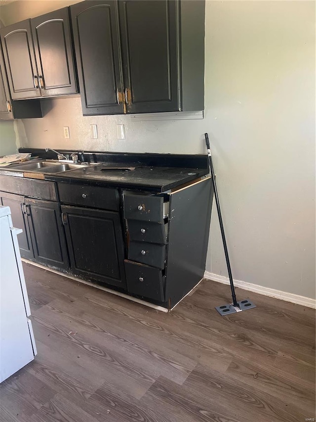 kitchen with sink, white stove, and hardwood / wood-style flooring