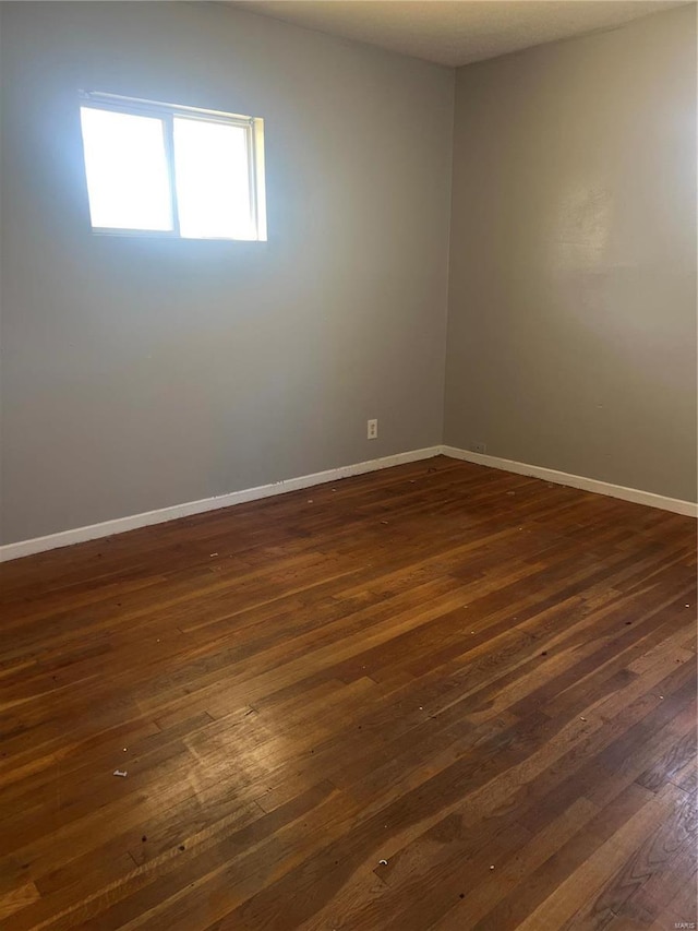 spare room with dark hardwood / wood-style flooring