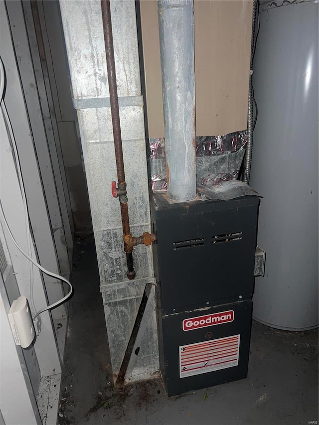 utility room featuring water heater