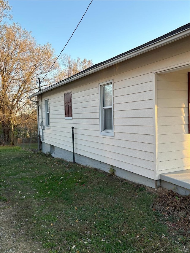 view of side of property with a yard