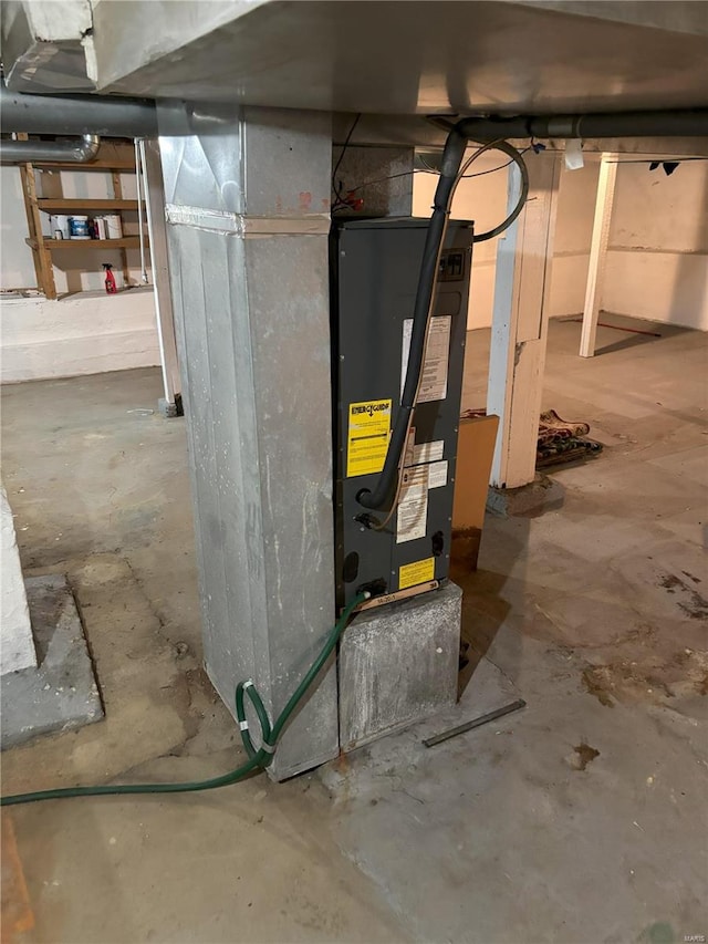 utility room featuring water heater