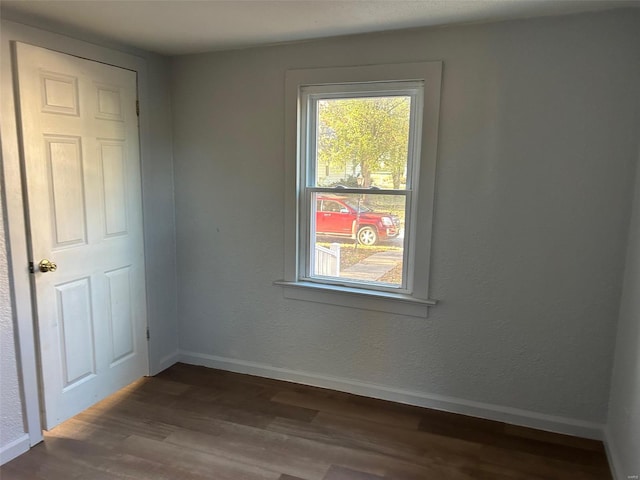 unfurnished room with dark hardwood / wood-style floors