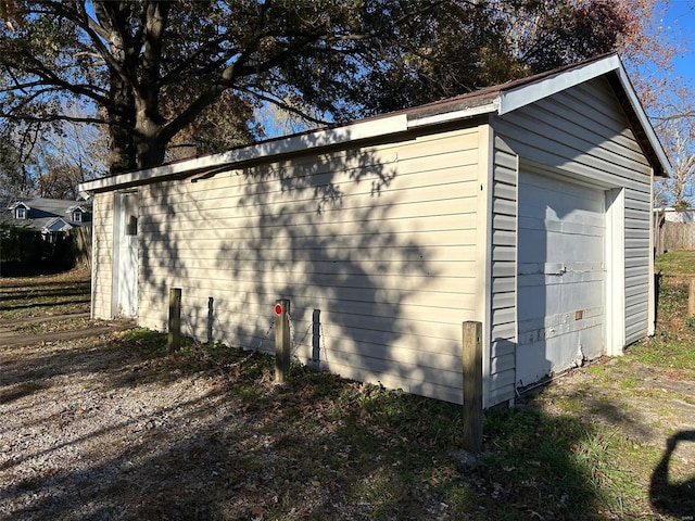 view of side of home featuring a garage and an outdoor structure