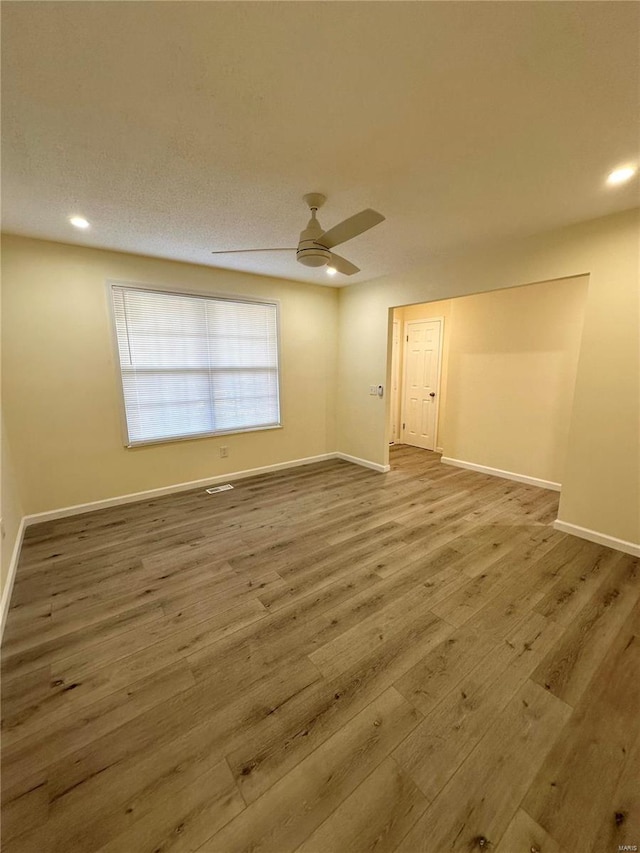 unfurnished room with hardwood / wood-style floors and ceiling fan