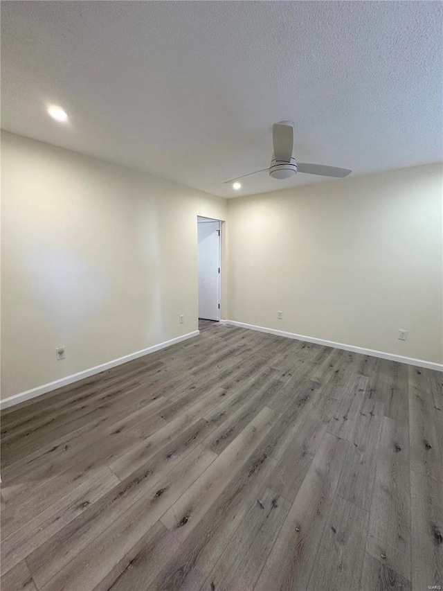 spare room featuring ceiling fan, light hardwood / wood-style floors, and a textured ceiling