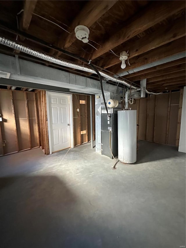 basement featuring heating unit and water heater