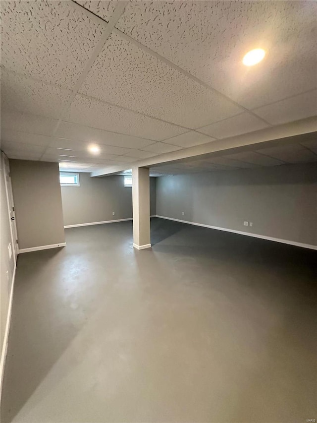 basement with a paneled ceiling