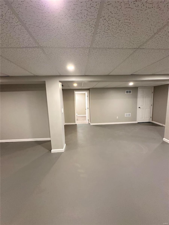 basement with a paneled ceiling