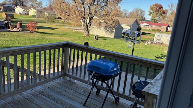 wooden deck featuring a yard and area for grilling