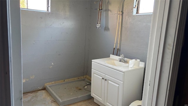 bathroom featuring a shower and vanity