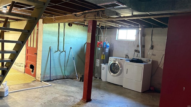 basement featuring washer and clothes dryer and water heater