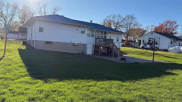 rear view of house featuring a yard