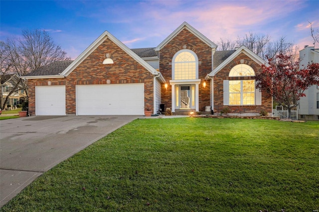 view of property with a garage and a yard