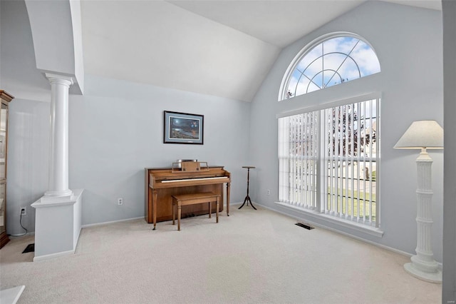 misc room featuring light colored carpet, high vaulted ceiling, and decorative columns