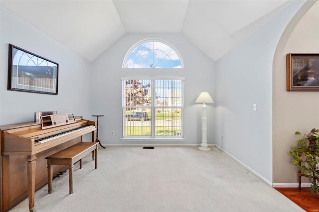 misc room featuring light carpet and vaulted ceiling