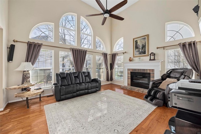 living room with a healthy amount of sunlight, a high ceiling, and light wood-type flooring