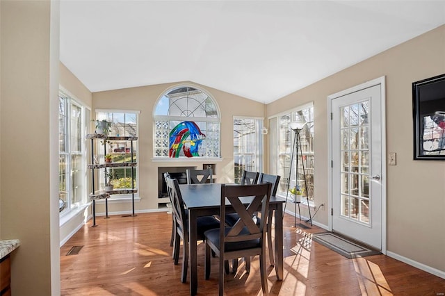 dining area featuring light hardwood / wood-style floors and lofted ceiling