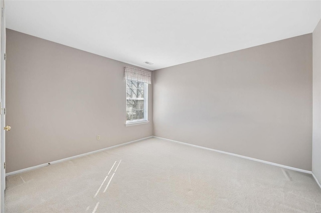 unfurnished room featuring light colored carpet