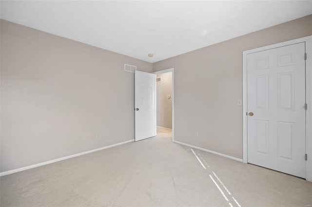 unfurnished bedroom with light carpet