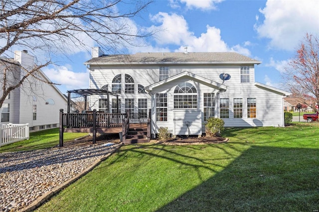 back of property featuring a lawn and a wooden deck