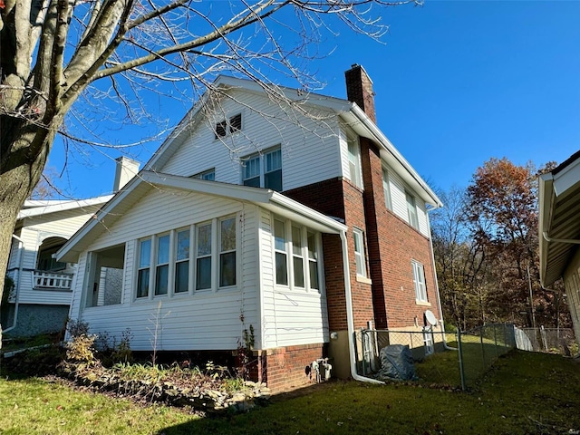 view of home's exterior with a lawn