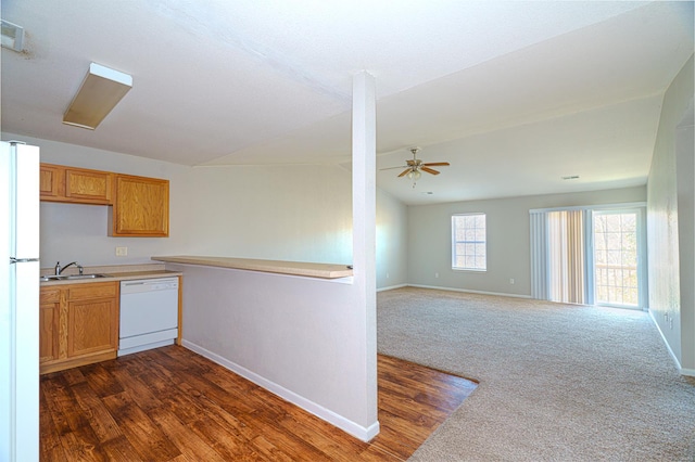 kitchen featuring white appliances, sink, vaulted ceiling, dark hardwood / wood-style floors, and ceiling fan