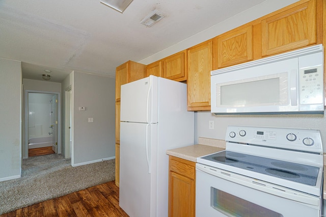 kitchen with white appliances and dark wood-type flooring