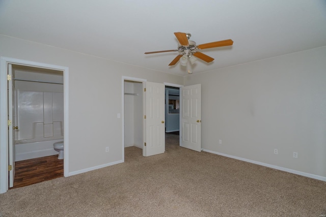 unfurnished bedroom with connected bathroom, ceiling fan, and carpet floors