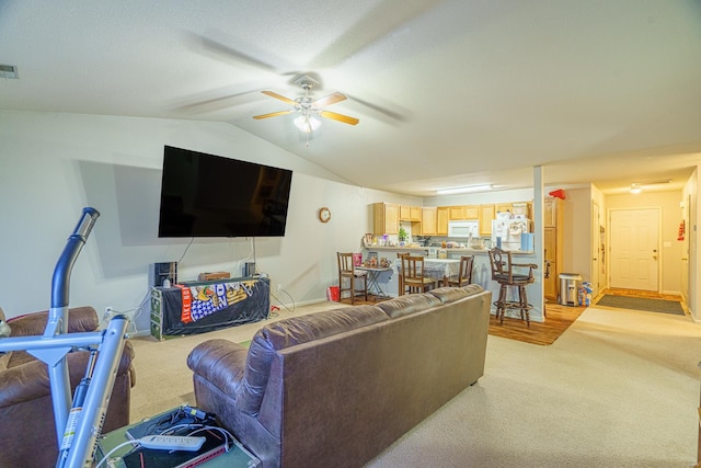 carpeted living room featuring ceiling fan and lofted ceiling