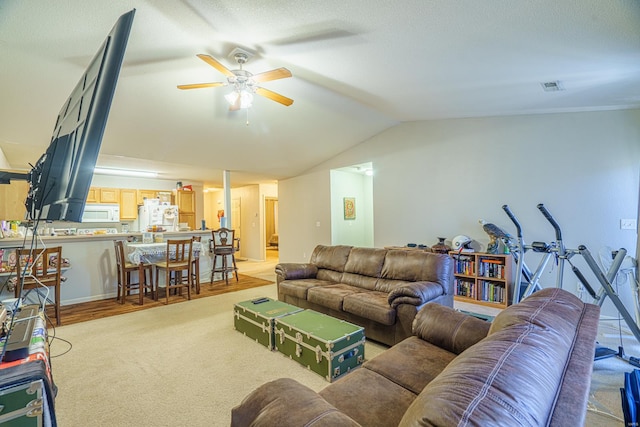 living room featuring light hardwood / wood-style flooring, ceiling fan, and lofted ceiling