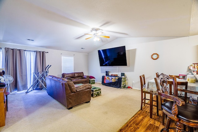 living room with hardwood / wood-style flooring, ceiling fan, and lofted ceiling