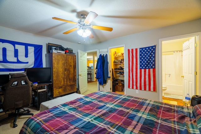 carpeted bedroom featuring ceiling fan, a walk in closet, a closet, and connected bathroom