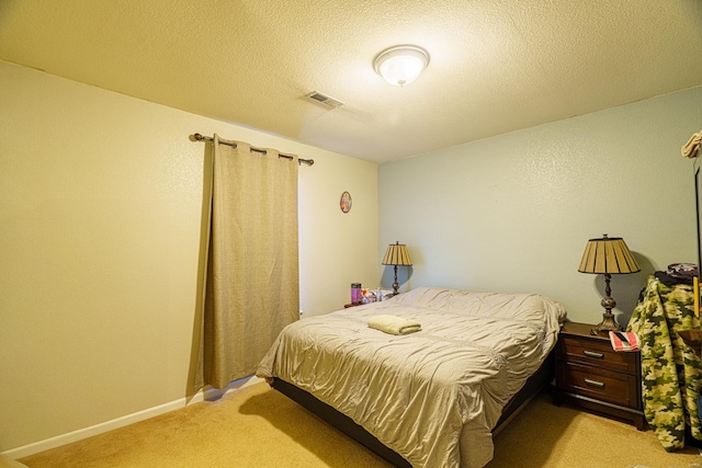 carpeted bedroom featuring a textured ceiling