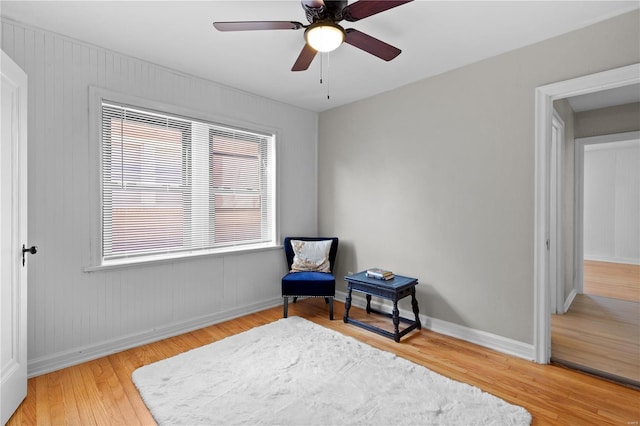 living area featuring ceiling fan and hardwood / wood-style flooring