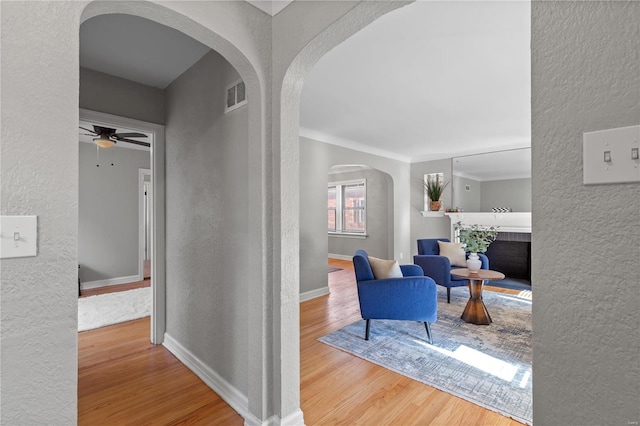 corridor featuring crown molding and hardwood / wood-style floors