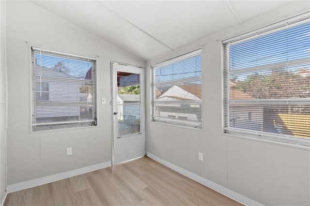 interior space featuring light hardwood / wood-style floors and lofted ceiling