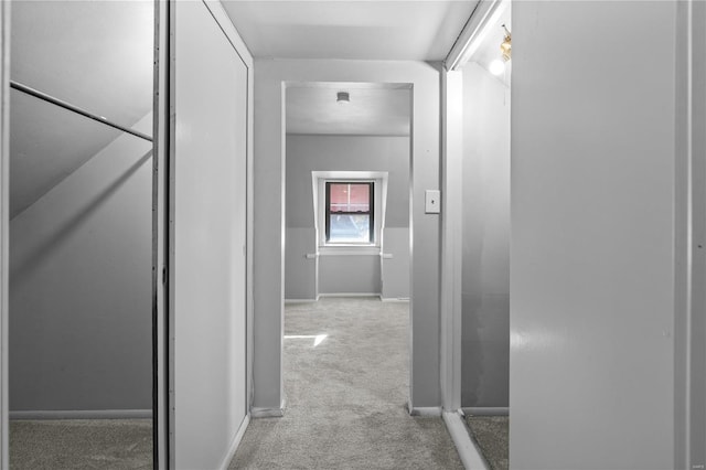 corridor featuring light carpet and lofted ceiling