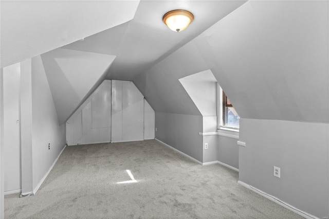 bonus room featuring light carpet and vaulted ceiling