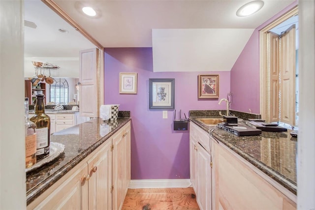 bathroom with sink, crown molding, and hardwood / wood-style floors