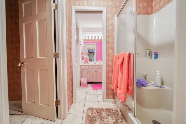 bathroom with vanity, a shower with shower door, and tile patterned flooring